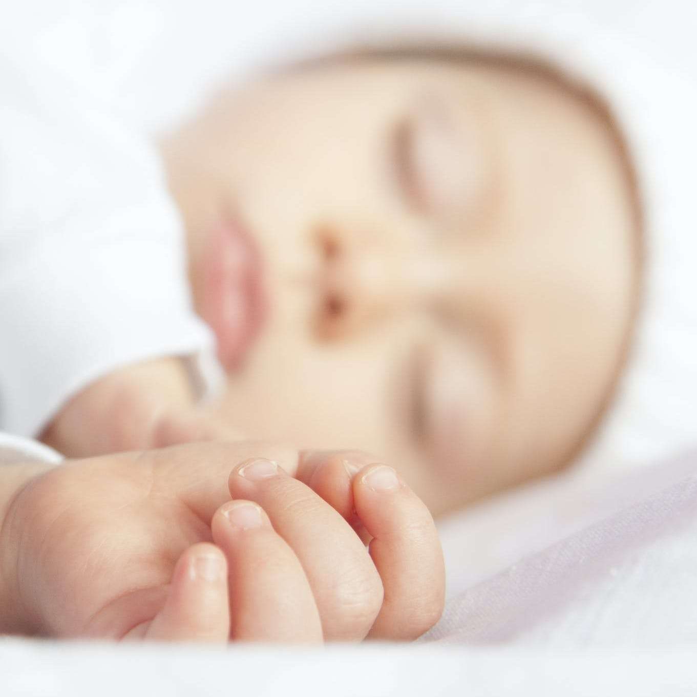 Baby Lying On White Textile