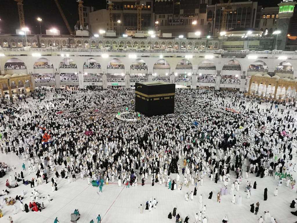 From above of crowded square around Kaaba cube in Great Mosque of Mecca at night time